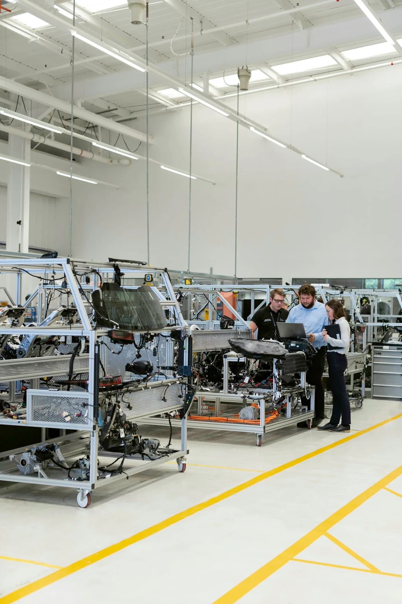 Engineers and workers collaborating inside a manufacturing facility