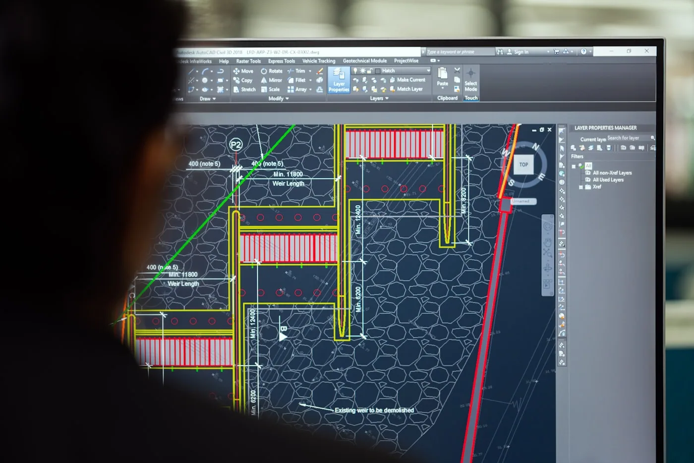 Engineering team reviewing structural drawings and technical plans